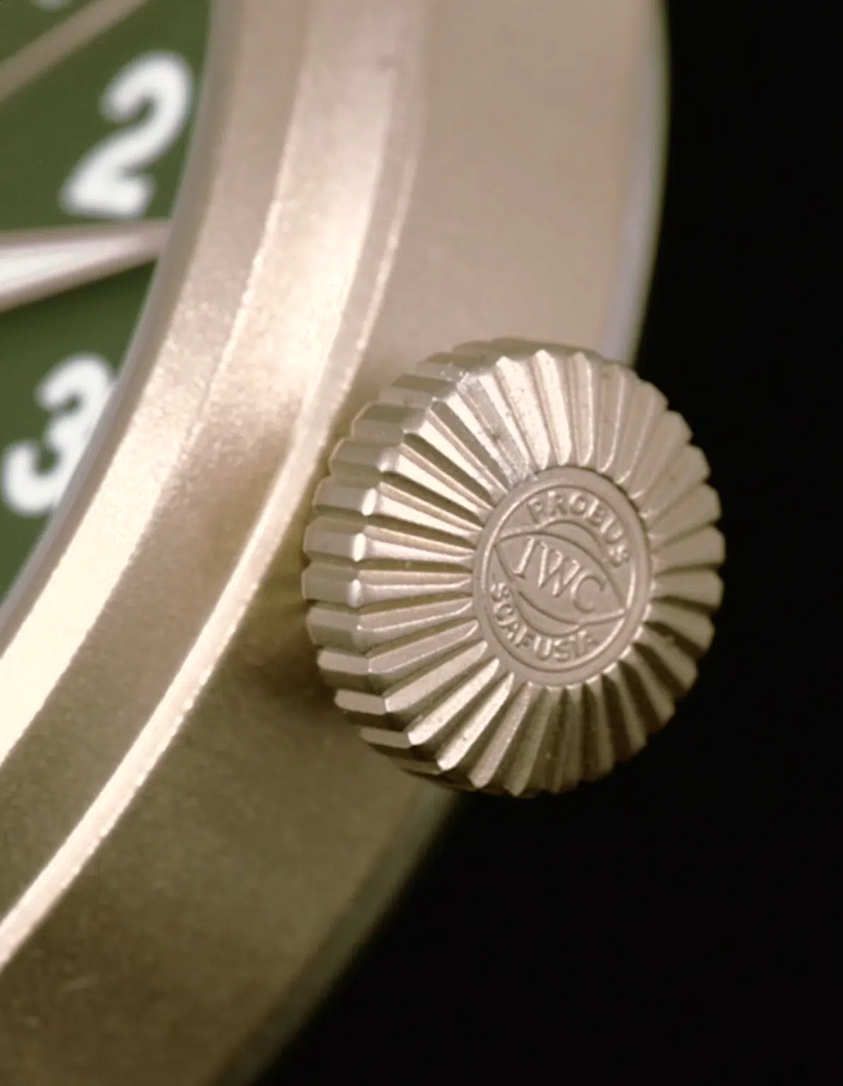 Close-up of the oversized crown on the IWC Big Pilot's Watch 43 Spitfire in bronze, featuring the iconic IWC logo and fine texturing