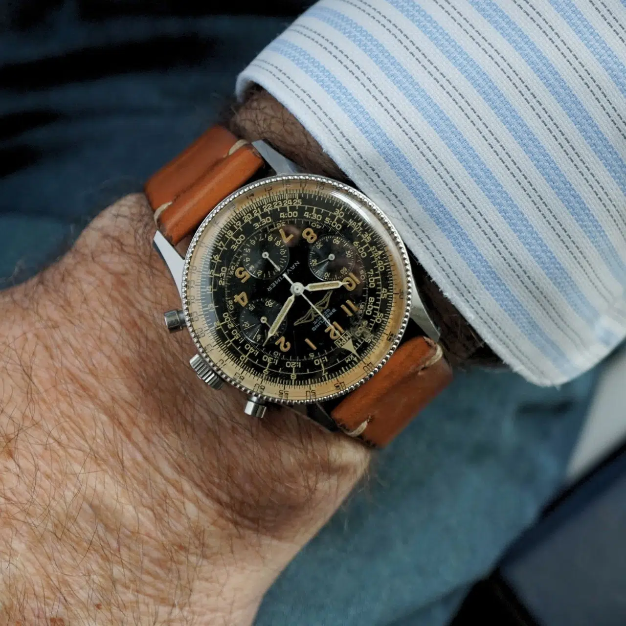 Vintage Breitling Navitimer 806 wrist shot showcasing its iconic black dial, AOPA logo, chronograph functions, and slide rule bezel with a leather strap