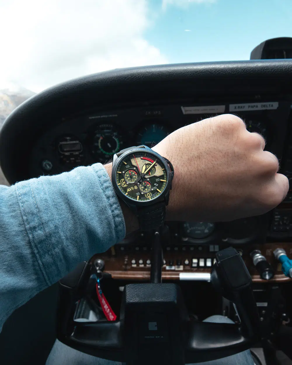 Aviation watch with detailed bezel in a pilot cockpit environment, illustrating the functional design for pilots