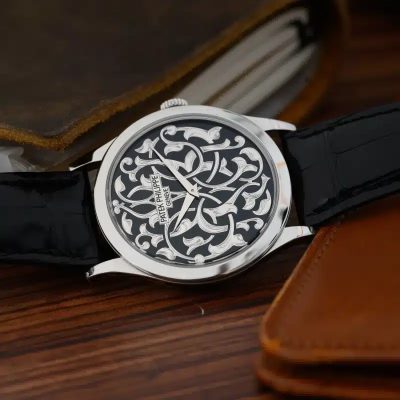 Patek Philippe rare wristwatch with hand-engraved white gold arabesque dial and black leather strap